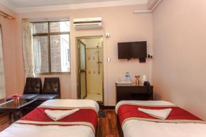 Postel nebo postele na pokoji v ubytování Hotel Nepalaya