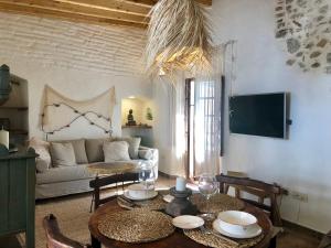 a living room with a table and a couch at Azogue Studios in Tarifa