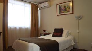 Ένα ή περισσότερα κρεβάτια σε δωμάτιο στο Hotel Real