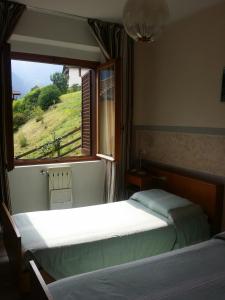 Postel nebo postele na pokoji v ubytování Albergo la Valle + 37 fotografií