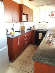 a kitchen with wooden cabinets and a counter top at Chevandeaux 1 - Merlot in Franschhoek