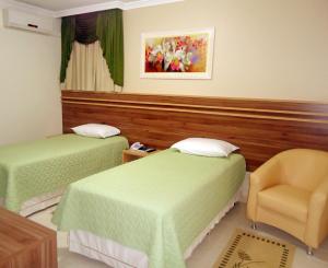 En eller flere senge i et værelse på Hotel Dom Baroni