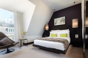 a bedroom with a large bed and a large window at South Place Hotel in London