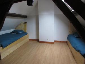 a bedroom with two beds in a attic at Etretat's Motel in Étretat