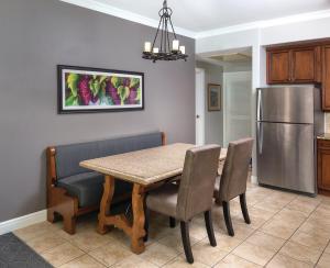 a kitchen with a table and chairs and a refrigerator at Vino Bello Resort in Napa +40 photos