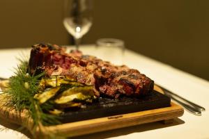 a plate of meat and vegetables on a table at Grand Hotel Admiral Palace in Chianciano Terme