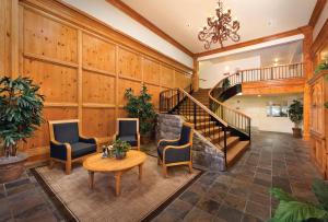 a living room with a staircase and a table and chairs at WorldMark Grand Lake in Monkey Island