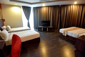 Postel nebo postele na pokoji v ubytování Jindagu Hotel Ipoh