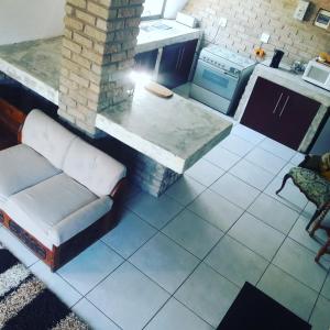 an overhead view of a kitchen with a couch and a table at Tsumeb Backpackers & Safari in Tsumeb