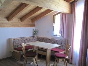 a dining room with a table and two chairs at Haus am Dorfplatz in Samnaun