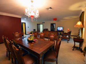 a dining room with a table and chairs at The Convention Center & Royal Suites Hotel in Kuwait