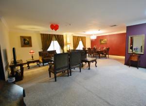 a living room filled with furniture and a dining room at The Convention Center & Royal Suites Hotel in Kuwait