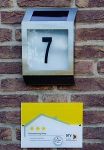a box with the number on a brick wall at FeWo Ferber in Andernach