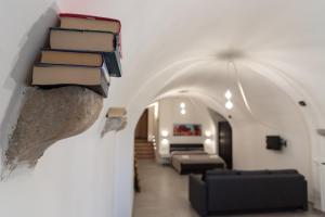 a room with a pile of books on a wall at Casa Vacanze Al Duomo Ibla in Ragusa