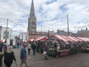 a group of people walking around a market with tents at Balderton Lodge in Balderton