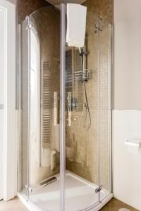 a shower with a glass door in a bathroom at Kerbaker 14 in Naples +28 photos