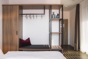 a bedroom with a bed and a dresser at Hayta Hotel Stuttgart Airport Messe in Filderstadt