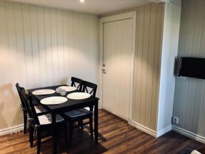 a dining room with a table and chairs and a door at Apartments in Svarte in Ystad