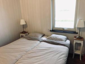 a small bedroom with two beds and a window at Apartments in Svarte in Ystad