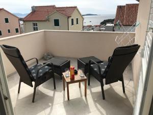 a balcony with two chairs and a table on a balcony at Hvar Apartments Felix in Hvar