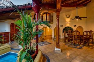 a living room with a table and a dining room at Casa de Arcos in Granada