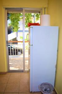 a white refrigerator in a room with an open door at Apartments Anesis Pantazis in Asprovalta