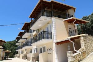 a large white building with black balconies on it at ANGELA STUDIOS in Parga