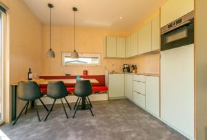 a kitchen with a table and chairs in it at De Lepelaar in Midsland