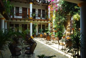 a patio with tables and chairs in front of a building at Hotel Grand Maria in San Cristóbal de Las Casas