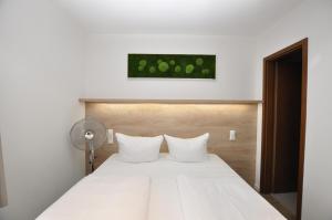 Postel nebo postele na pokoji v ubytování Hotel Perlach Allee by Blattl