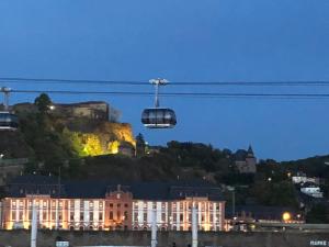 a cable car flying over a building with a castle at Humboldtruh in Weitersburg