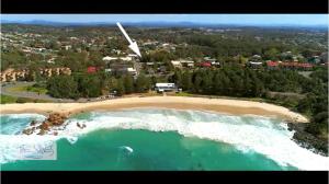 an aerial view of a beach and the ocean at The Waves Port Macquarie in Port Macquarie