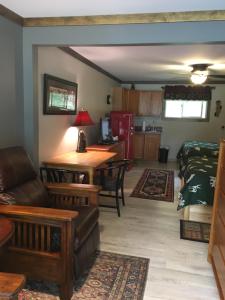 a living room with a couch and a table at Warrensburg Inn & Suites - 6 Mi to Lake George in Warrensburg