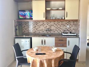 a kitchen with a table and chairs in a room at Serendi Apart Hotel in Alanya