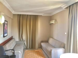 a living room with two couches and a couch at Serendi Apart Hotel in Alanya