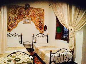 A bed or beds in a room at Dar Hafsa