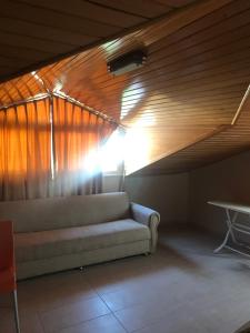 a couch in a room with a wooden ceiling at Serendi Apart Hotel in Alanya