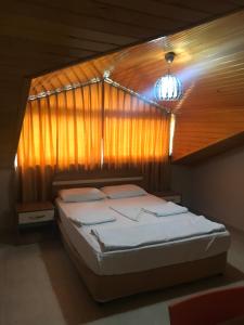 a bedroom with a bed with a wooden wall at Serendi Apart Hotel in Alanya