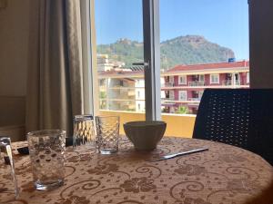 a table with glasses and a view of a building at Serendi Apart Hotel in Alanya