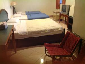 Un pat sau paturi într-o cameră la Hotel Morning Glory