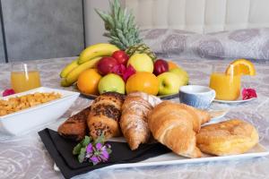 a table topped with a plate of bread and fruit at Cala Caterina Rooms in Villasimius