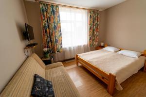 a bedroom with a bed and a large window at Hotel Mare & Restaurant in Roja