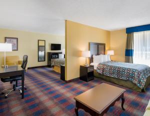 a hotel room with two beds and a desk at Americas Best Value Inn - Clayton in Clayton