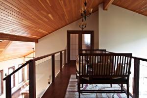 a hallway with a wooden ceiling and a chair at High Hopes Bed and Breakfast in Hope