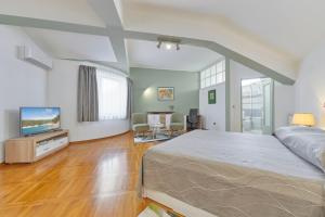 Кровать или кровати в номере Villa Giardina Apartments