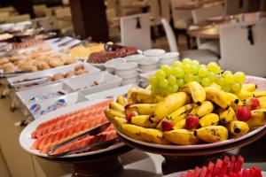 a plate of bananas and grapes and other fruits at Blue Tree Premium Faria Lima in São Paulo