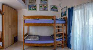 Postel nebo postele na pokoji v ubytování Apartments Podlesek
