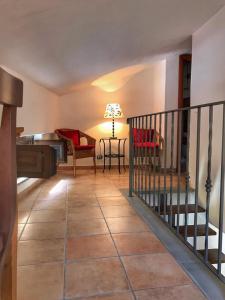 a living room with a staircase and a table with a lamp at Casa Santicelli Maratea ' I CARPINI ' in Maratea