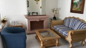 a living room with a couch and a fireplace at Gran Hotel Hacienda De La Noria in Aguascalientes