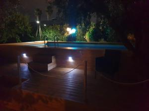 a night view of a swimming pool with lights at Barbara B&B in Fontane Bianche